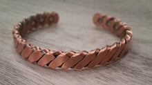 Load image into Gallery viewer, Copper bracelet on a wooden surface
