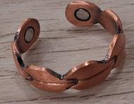 Copper bracelet on a wooden surface