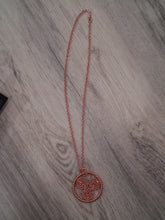 Load image into Gallery viewer, Copper necklace with a circular pendant on a wooden surface
