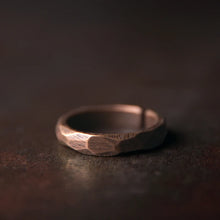 Load image into Gallery viewer, Bronze ring on a dark textured surface
