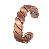 Copper ring with a textured design on a white background