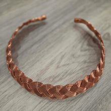 Load image into Gallery viewer, A Pure copper hand woven necklace statement piece displayed on a gray wood-textured surface.
